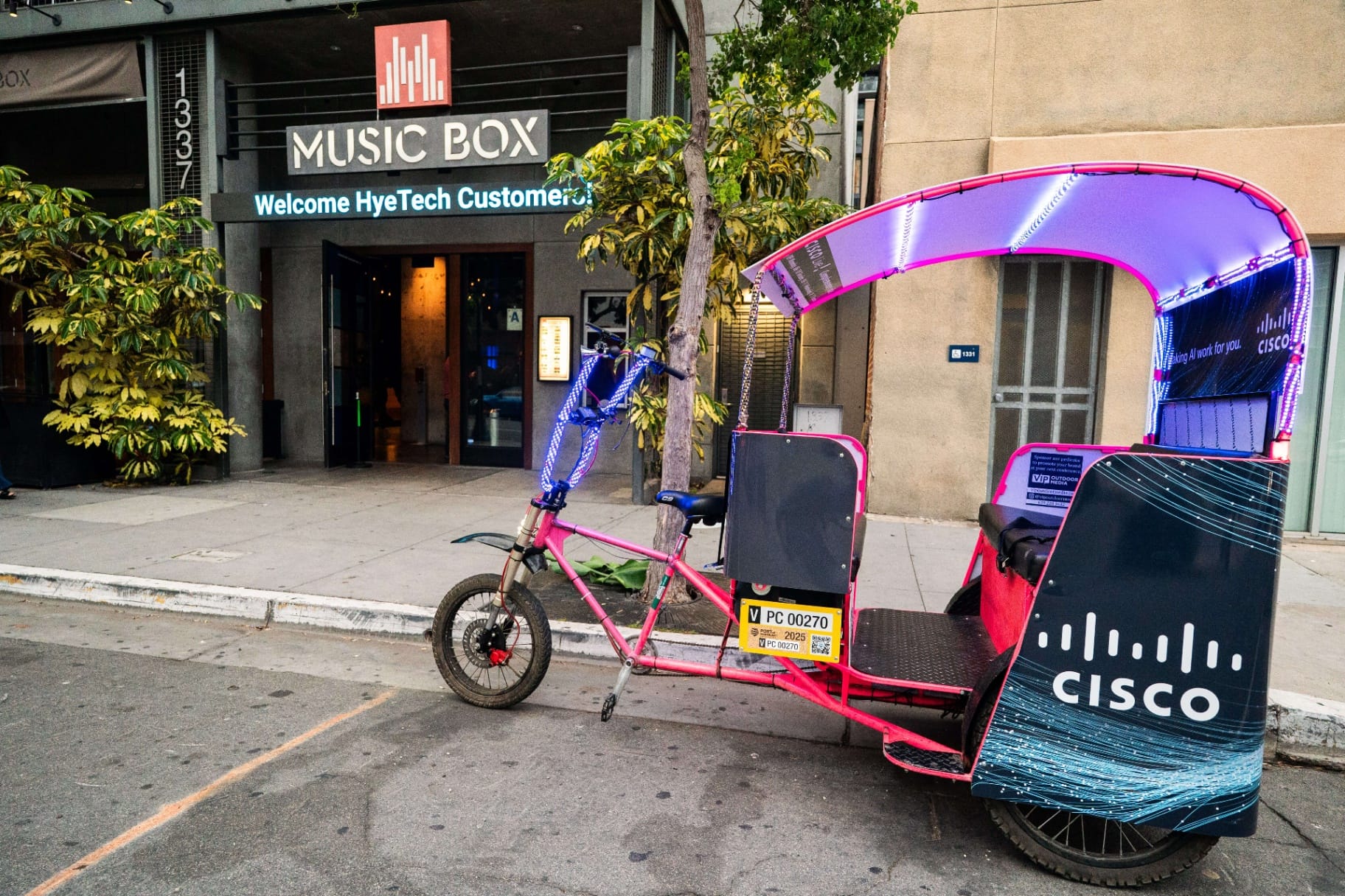 Cisco Live LED-lit pedicab outside a music venue at night in San Diego