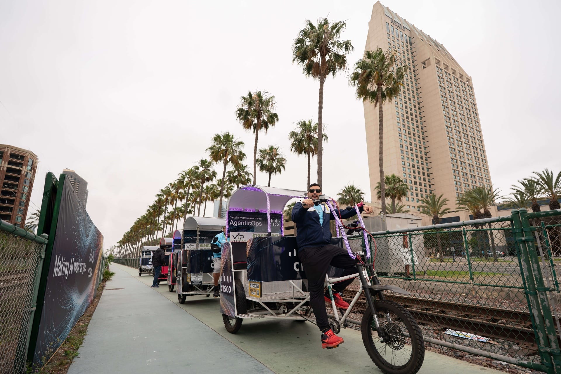 Cisco branded pedicab fleet with riders outside the San Diego Convention Center