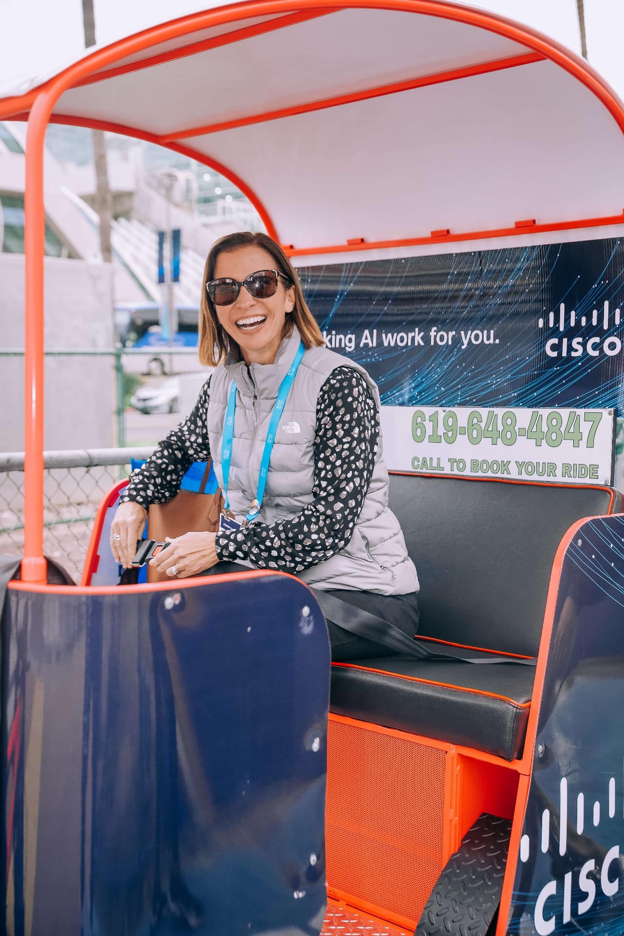 Happy passenger in branded pedicab at San Diego event