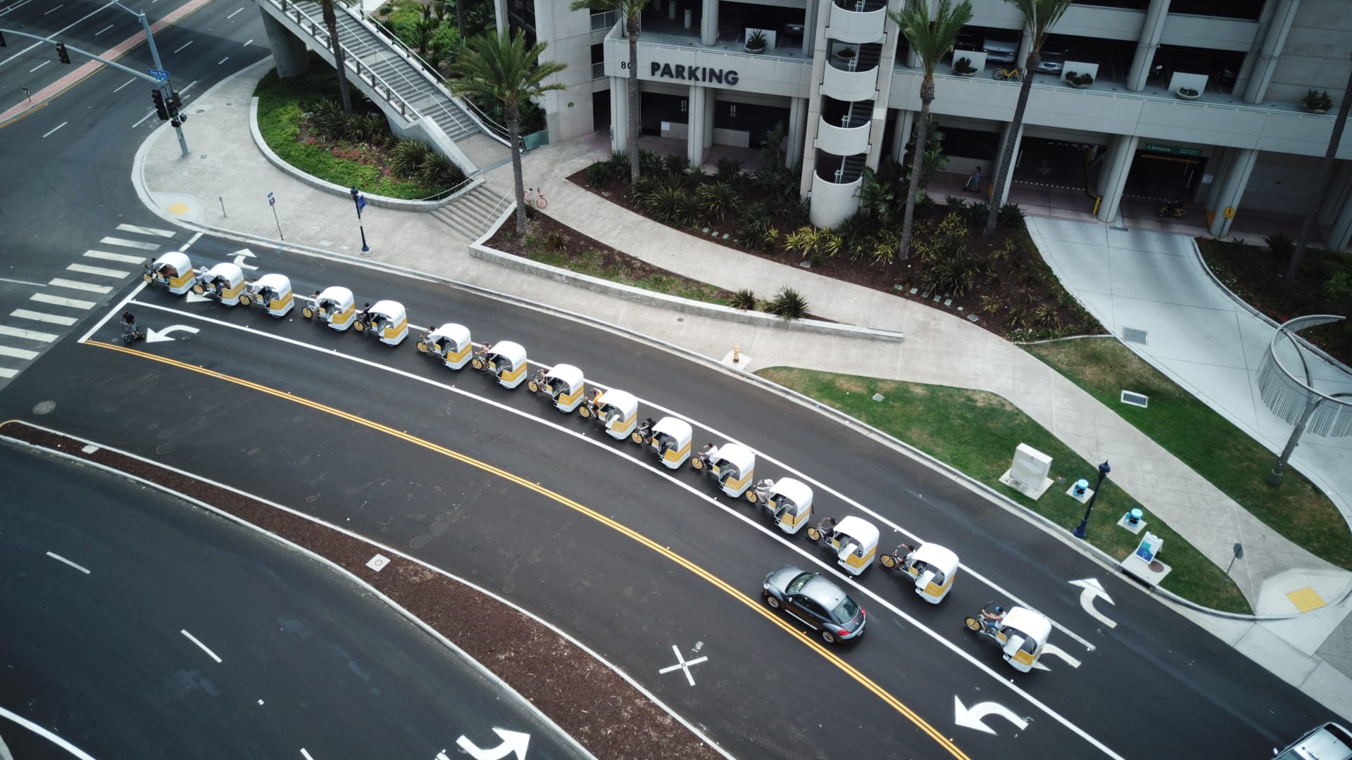 Aerial view of a branded pedicab fleet lined up through downtown San Diego