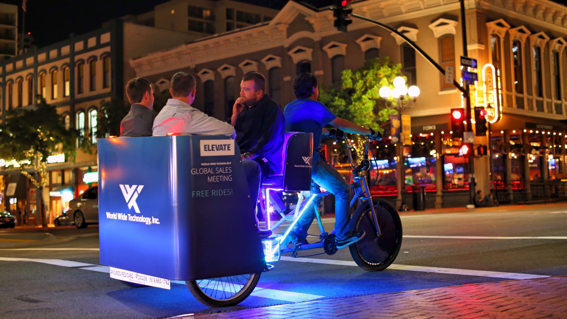 World Wide Technology branded LED pedicab at night in San Diego's Gaslamp Quarter